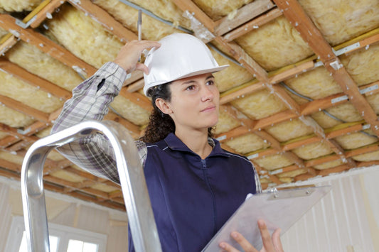 construction worker calculating insulation for building