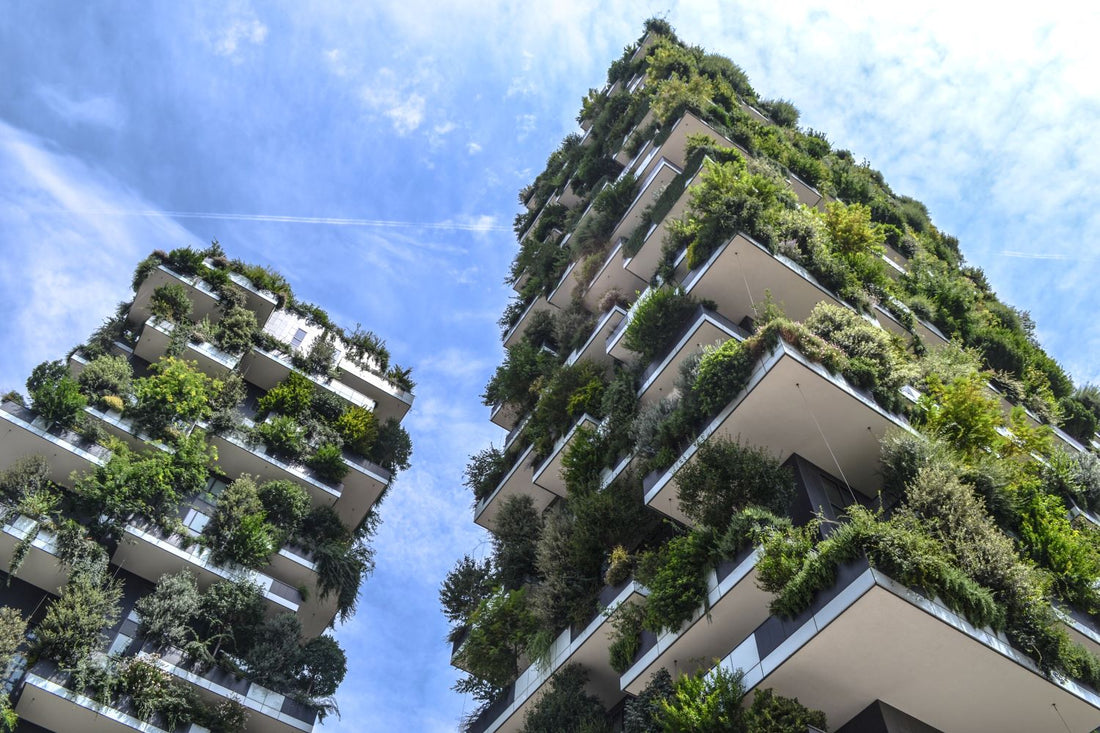 green building structures with trees and shrubbery growing out from them.